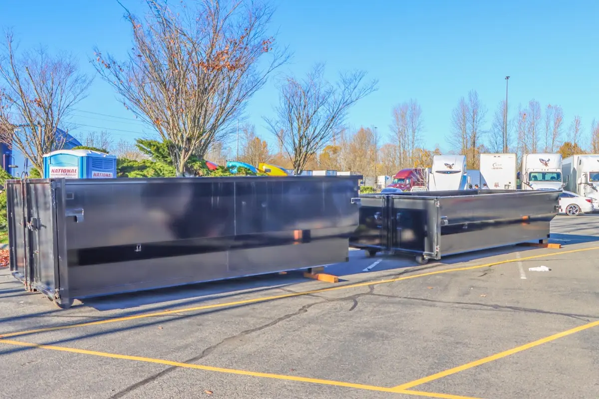 Professional dumpster rental service with roll-off container on residential driveway in Gilmer